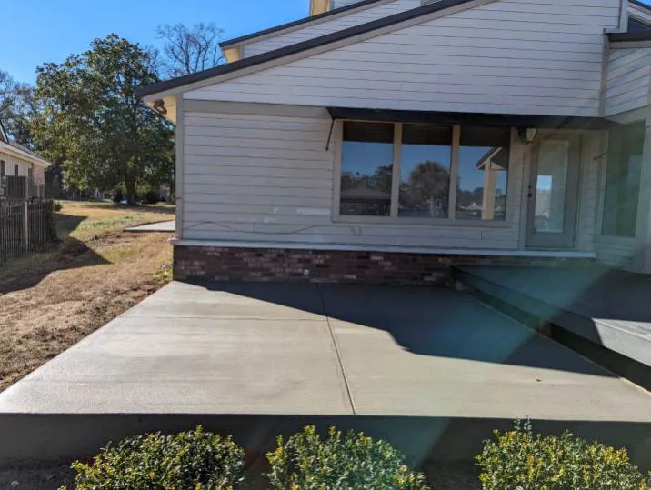 Concrete patio and walk at a beige house