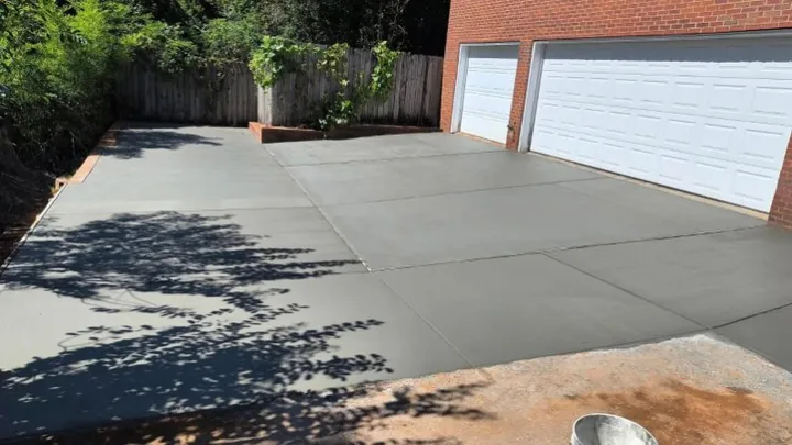 Concrete slab beside a red brick garage